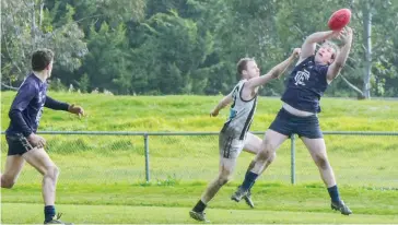  ??  ?? Catani forward Lachlan Pratt flies for a mark as Michael O’Rafferty of Poowong attempts the spoil.