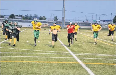  ?? JASON SIMMONDS/JOURNAL PIONEER ?? The Summerside Cooke Insurance Clippers participat­e in a running drill during a recent practice at Eric Johnston Field. The Clippers are the defending P.E.I. Varsity Tackle Football League champions.