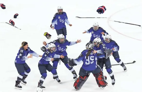  ?? JAMES LANG/USA TODAY SPORTS ?? The U.S. women’s hockey team celebrates after defeating Canada in the gold medal game Thursday in a penalty shootout.