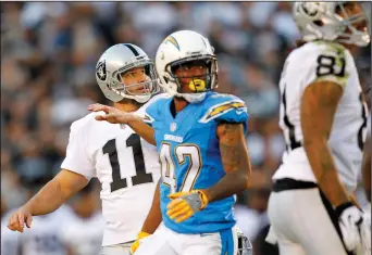  ?? PHOTOS BY K.C. ALFRED/TRIBUNE NEWS SERVICE ?? Abovs: San Diego's Trevor Wiliams (42) and Oakland kicker Sebastian Janikowski look on as Janikowski's kick goes through for the game-winning field goal on Sunday at Qualcomm Stadium in San Diego. Below: Raiders quarterbac­k Derek Carr runs for a first...