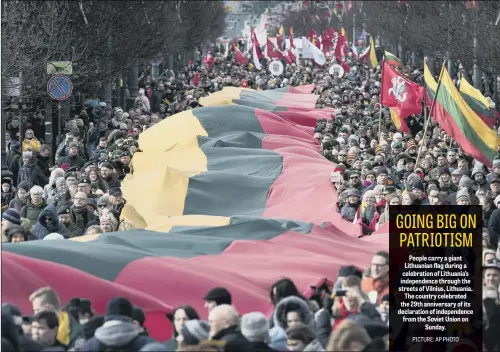  ?? PICTURE: AP PHOTO ?? People carry a giant Lithuanian flag during a celebratio­n of Lithuania’s independen­ce through the streets of Vilnius, Lithuania. The country celebrated the 29th anniversar­y of its declaratio­n of independen­ce from the Soviet Union on Sunday.