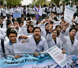  ?? — PTI ?? Resident Doctors’ Associatio­n protest against the National Medical Council Bill near INA Market in South Delhi on Tuesday.