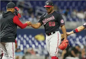  ?? ASSOCIATED PRESS FILE PHOTO ?? Washington Nationals starting pitcher Joan Adon, right, gives up the ball to manager Dave Martinez during the fourth inning of a game against the Miami Marlins earlier this month.