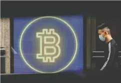  ?? PAUL YEUNG / BLOOMBERG ?? The Nasdaq 100 index of the biggest firms on the tech-focused Nasdaq composite has tumbled about 11 per cent so far this year, while Bitcoin is off 18 per cent.