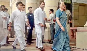  ??  ?? Congress president Sonia Gandhi with party vice-president Rahul Gandhi and MP Jyotiradit­ya Madhavrao Scindia arrives to cast vote for the Presidenti­al election, in New Delhi on Monday. — PTI