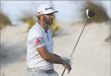  ?? The Associated Press ?? STRAIGHT SHOOTER: Dustin Johnson, here watching his tee shot on No. 16, ties for the second-round lead in the Hero World Challenge Friday in the Bahamas. Johnson, this year’s U.S. Open winner, and Hideki Matsuyama finished 36 holes at 12-under 132.