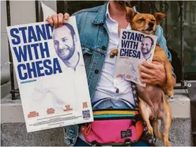  ?? Nick Otto / Special to The Chronicle ?? Left: Brad Chapin, holding Blanch, supports District Attorney Chesa Boudin. Right: Volunteer Stephanie Lehman seeks signatures on a petition to recall Boudin.