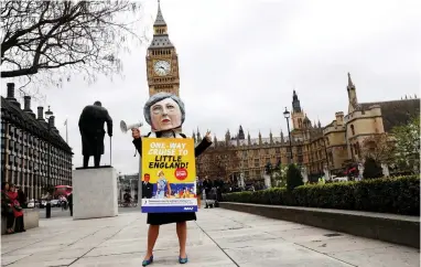  ?? PICTURE: REUTERS ?? GOING, GOING, GONE: Anti-Brexit protester with a giant Theresa May head wears a sandwich board outside Parliament on the day the Prime Minister will announce that she has triggered the process by which Britain will leave the EU.