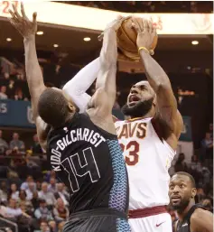  ??  ?? Charlotte Hornets forward Michael Kidd-Gilchrist (left) blocks Cleveland Cavaliers forward LeBron James during the first half at the Spectrum Centre. — USA TODAY Sports photo