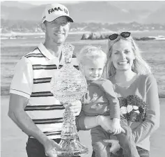  ??  ?? Vaughn Taylor poses with the trophy, along with wife Leot and son Locklyn, after winning the AT&T Pebble Beach National Pro-Am at the Pebble Beach Golf Links in Pebble Beach, California. - AFP photo