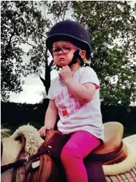  ??  ?? LOTTIE’S 1ST HORSE RIDE