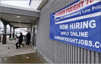  ?? THE ASSOCIATED PRESS ?? A “Now Hiring” sign hangs on the front wall of a Harbor Freight Tools store in Manchester, N.H. Are more people finally starting to look for work? A report to be issued today may answer that question.