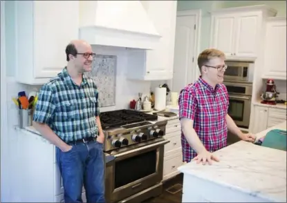  ??  ?? Paul Arguin, left, and Chris Taylor, who have been competing on the amateur baking circuit for several years, in the kitchen of their Atlanta home.