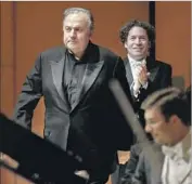  ?? Jay L. Clendenin Los Angeles Times ?? PIANIST YEFIM BRONFMAN, left, is applauded by Los Angeles Phil conductor Gustavo Dudamel.