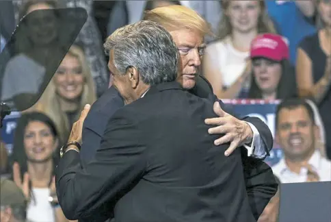  ?? Harrison Jones/Post-Gazette ?? Rep. Lou Barletta, R-Pa., embraces President Donald Trump during a rally Thursday in Wilkes-Barre.
