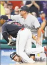  ?? David Maxwell / Getty Images ?? The Indians’ Jose Ramirez watches the ball go out of play as the Yankees’ Austin Romine slides into third base in the seventh inning Saturday.