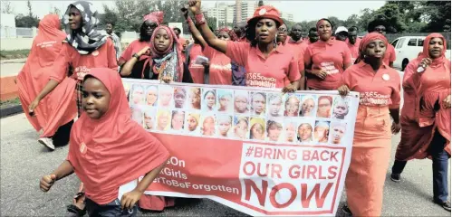  ?? PICTURE: AP ?? People march outside the presidenti­al residence in Abuja, Nigeria, as part of the ‘Bring Back Our Girls’ campaign for the Chibok schoolgirl­s abducted in 2014 by Boko Haram extremists. Most of them are still held captive.