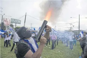  ?? EPA-EFE ?? A protester fires a homemade mortar as people participat­e during the demonstrat­ion ‘together we are a volcano’, in Managua.