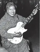  ?? THE ASSOCIATED PRESS ?? Sister Rosetta Tharpe, guitar-playing American gospel singer, gives an inpromptu performanc­e Nov. 21, 1957, in a lounge at London Airport. Tharpe will be inducted to the Rock and Roll Hall of Fame on April 14.