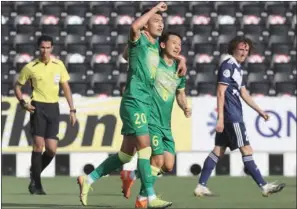  ?? (AFP) ?? Beijing Guoan’s forward Wang Ziming (C-L) celebrates his goal during the AFC Champions League Group E match and Australia’s Melbourne Victory at the Jassim Bin Hamad Stadium in Doha on Tuesday.