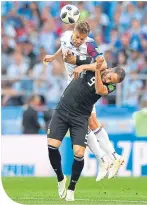  ??  ?? Iceland’s Kari Arnason gets above Argentina’s Gonzalo Higuain