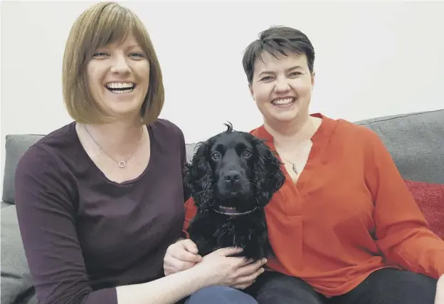  ??  ?? 0 Ruth Davidson – pictured with partner Jen Wilson and their dog Wilson – has ruled out any interest in a move to Westminste­r and revealed her past mental health issues