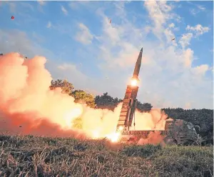  ??  ?? Clockwise from main picture: a missile is fired during an exercise in South Korea; Kim Jong Un; Nikki Haley, US ambassador to the UN, speaks to Chinese ambassador Liu Jieyi.