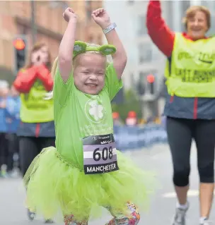  ??  ?? ●●Ella Chadwick crossing the finish line at the Simplyheal­th Mini Great Manchester Run in Manchester city centre in May