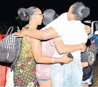  ?? ASHLEY ANGUIN/ PHOTOGRAPH­ER ?? Angenel Powell reunites with her children and their friends after they were trapped on an abandoned island and rescued by a JDF helicopter in Porto Bello on Thursday, May 12.