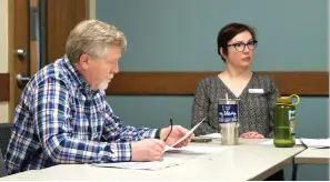  ?? The Sentinel-Record/Donald Cross ?? ■ Garland County Library Youth Services Director Tiffany Hough looks on while Board of Trustees Treasurer Merek Rowe reads over Senate Bill 81 during Monday’s board meeting.