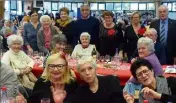  ??  ?? Les membres du CCAS et le maire (debout à droite) au milieu d’une salle comble et joyeuse. (Photo S. F.)