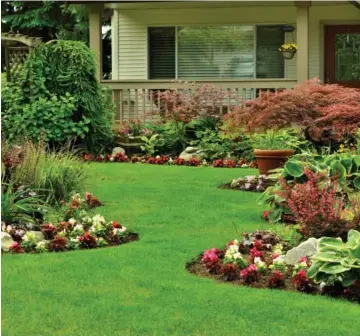  ??  ?? Hiring a profession­al landscaper can help transform your yard from an everyday front lawn into a beautiful oasis.