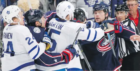  ?? AP ?? Players from both teams and an official intervene as Toronto’s Matt Martin, centre, scuffles with Josh Anderson of the Blue Jackets Wednesday night in Columbus, Ohio.