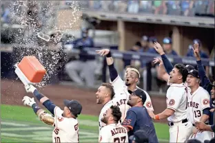  ?? AP - Gregory Bull ?? Astros players celebrate Carlos Correa’s game- winning home run Thursday, which extended the AL Championsh­ip Series against the Rays to a sixth game.