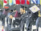  ?? MATIAS J. OCNER mocner@miamiheral­d.com ?? Miami Dade College students enjoy the ceremony Saturday at loanDepot Park.