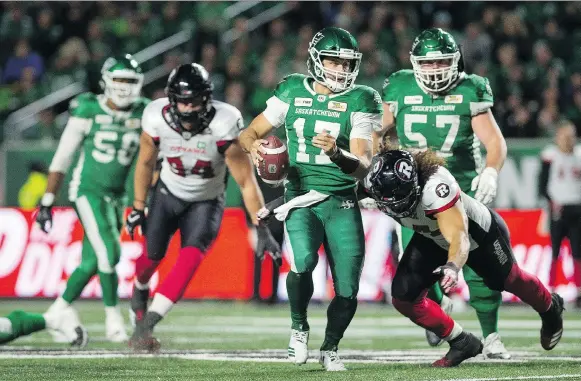  ?? BRANDON HARDER ?? Roughrider­s quarterbac­k Zach Collaros, shown trying to elude being tackled by the Redblacks, had a rough night Saturday during the 30-25 loss to Ottawa.