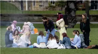  ??  ?? Joys of spring: A group of youngsters at the Meadows in Edinburgh