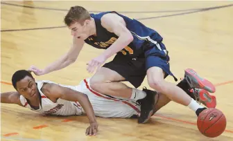  ?? STAFF PHOTO BY MATT WEST ?? TECH-NICAL DIFFICULTY: Tech Boston’s Javon Pierre watches a loose ball as Hanover’s Jake McInerney crashes on top of him during last night’s Division 3 South semifinal. Tech Boston advanced to the title game with a 58-47 victory.