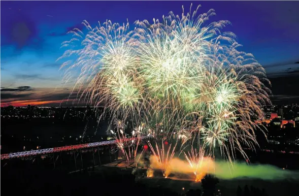  ?? ED KAISER /EDMONTON JOURNAL ?? With the High Level Bridge lit up in red and white, Canada Day fireworks illuminate the downtown skyline last week. While profession­al fireworks such as this won’t be affected, proposed changes to the Alberta Fire Code will make it difficult to legally...