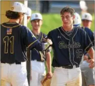  ?? PETE BANNAN-DIGITAL FIRST MEDIA ?? Exton’s Tom Caufield congratula­tes Ron Tracy after he scored in the fourth inning of their victory 16-0 over West Chester.