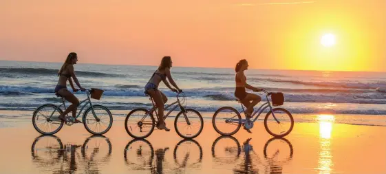  ??  ?? TOP: Cycling on Daytona Beach. ABOVE: The Museum of Arts &amp; Sciences in Daytona Beach. Daytona Beach Area CVB