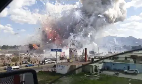  ?? (Jose Luis Tolentino via AP) ?? This image made from video recorded from a passing car shows an explosion ripping through the San Pablito fireworks' market in Tultepec, Mexico, Tuesday, Dec. 20, 2016. Sirens wailed and a heavy scent of gunpowder lingered in the air after the...