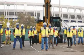  ?? K.C. ALFRED U-T ?? Constructi­on workers pose for a photo during a groundbrea­king ceremony for the SDSU Mission Valley project on Aug. 17, 2020. Aztecs football will play in new 35-000 seat facility.