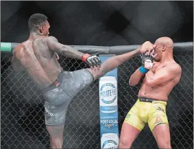  ?? ANDY BROWNBILL/AP PHOTO ?? Israel Adesanya, left, kicks Anderson Silva during their middleweig­ht bout at the UFC 234 event on Sunday at Melbourne, Australia.