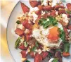  ?? CHRISTOPHE­R SIMPSON/NEW YORK TIMES ?? Smoky sweet potatoes with fried eggs and almonds.