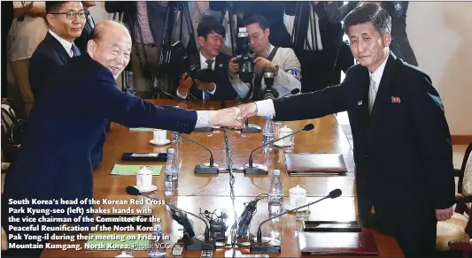  ?? Photo: VCG ?? South Korea’s head of the Korean Red Cross Park Kyung-seo (left) shakes hands with the vice chairman of the Committee for the Peaceful Reunificat­ion of the North Korea Pak Yong-il during their meeting on Friday in Mountain Kumgang, North Korea.