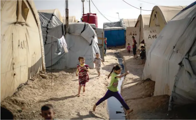  ??  ?? KIRKUK: Children play in the Yahyawa camp for internally displaced Turkmen on the outskirts of Kirkuk yesterday. Over 600 families from Tel Afar, a town west of Mosul, have been living in the camp for two years and are hoping for their city to be...