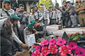  ?? AFP/Getty Images ?? Israeli security forces attend Tuesday’s funeral for border police officer Solomon Gavria, 20, one of three Israeli guards killed in a shooting attack by a Palestinia­n man on the edge of Har Adar, an affluent community northwest of Jerusalem.