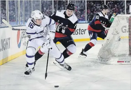  ?? PATRICK MCDERMOTT GETTY IMAGES ?? Mitch Marner of the Toronto Maple Leafs controls the puck against Washington’s Dmitry Orlov on Sunday in Annapolis, Md.