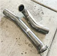  ??  ?? On the 1994-1997 7.3L applicatio­ns, the true gains in an aftermarke­t exhaust kit come from the down pipe. The factory down pipe was smashed virtually flat for clearance between the firewall and engine, but the engineers at Banks were able to design a full 3” down pipe that outflows the factory piece by 26%